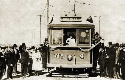 Miss Membrey cuts the ribbon from the driver's cab of FNPTT No 4. Opening day at Miller Street, 1 April 1920. Photograph City of Darebin