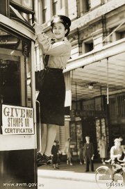 M&MTB conductress changing the route number in the city. Source: Australian War Museum