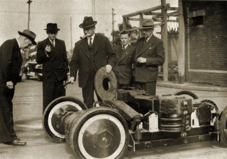 M&MTB Chairman H.H. Bell wielding a hammer during inspection of new PCC St Louis B3 trucks for prototype tram 980 at Preston Workshops, 1949. M&MTB photograph.