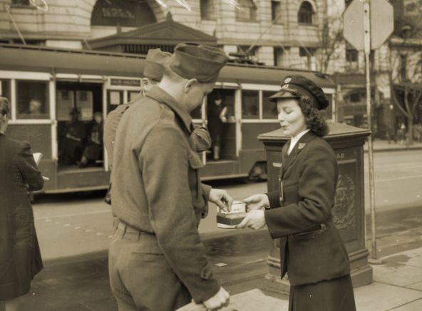 M&MTB conductress selling Red Cross buttons, 23 June 1944. Photograph Australian War Memorial