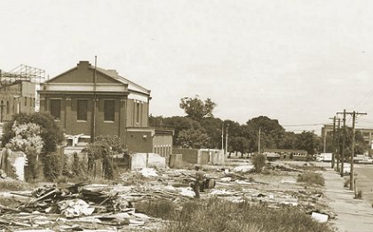 Demolition of a row of houses has exposed the rear of the old St Kilda 
            substation, not long before it too was demolished in 1967. Photograph from the Peter W Duckett collection.